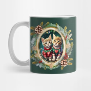 Two cute kittens wearing festive Christmas sweaters with red hearts, in a winter themed picture frame with pinecones and winter berries Mug